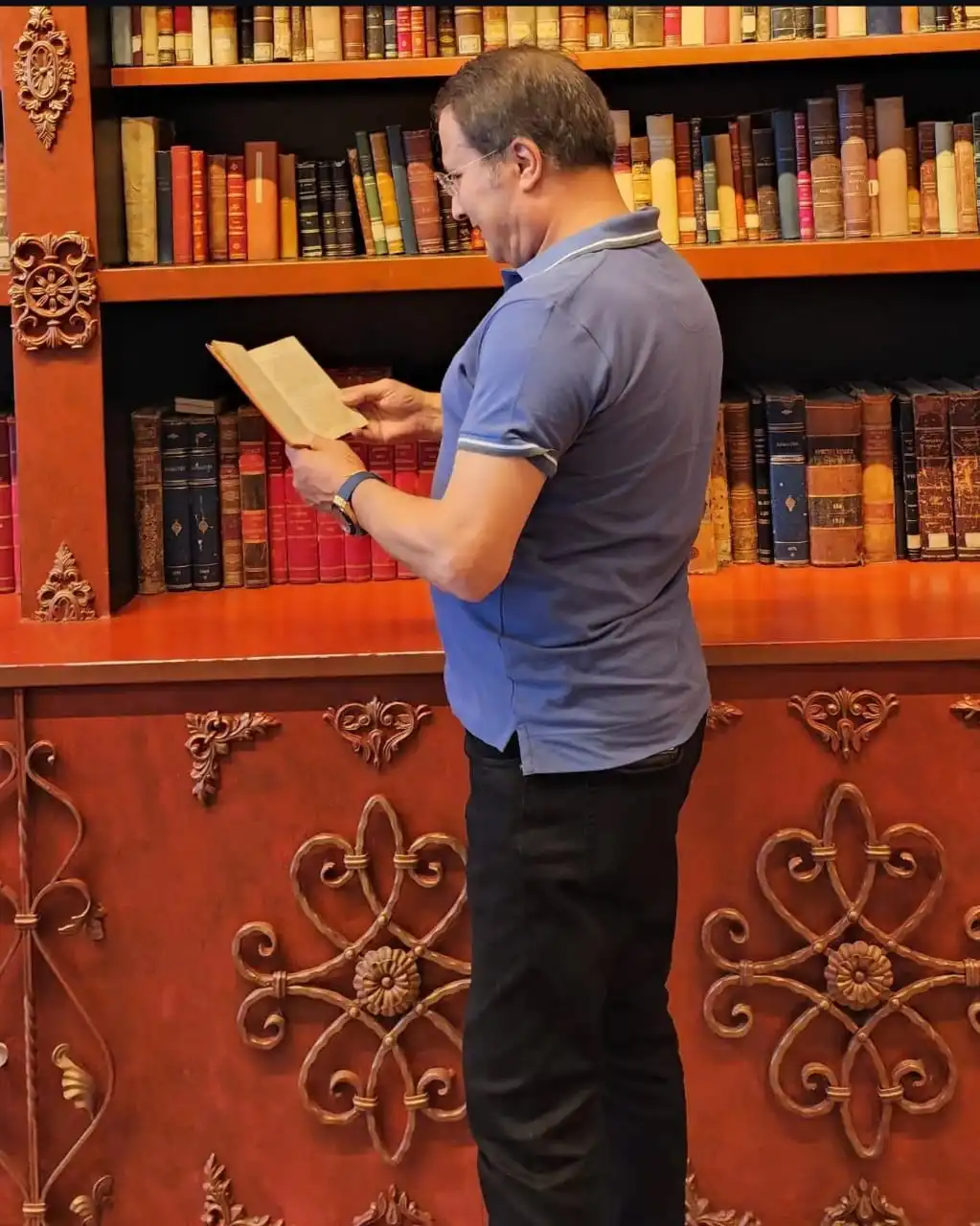Samad reading a book about cooking