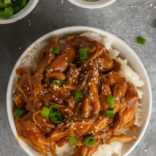 Crock Pot Teriyaki Chicken over rice with sesame seeds