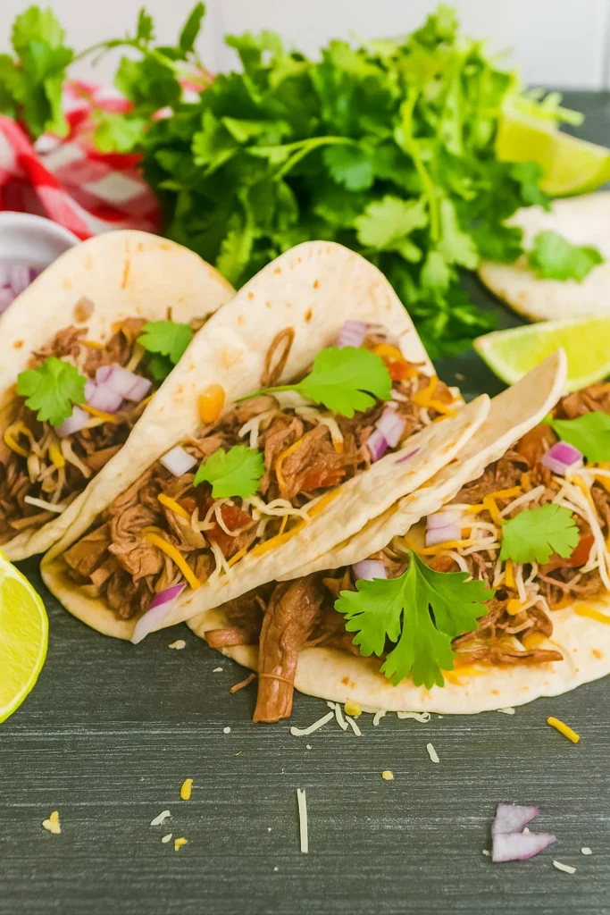 Slow cooker shredded beef tacos with toppings